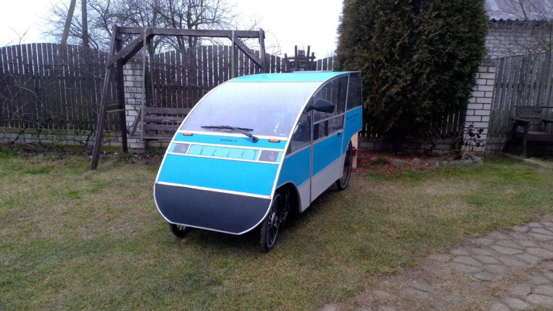 Электро веломобиль деревни под дождем. Electric velomobile of the village in the rain